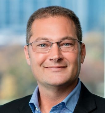 man with glasses smiling