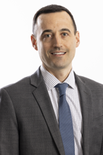 man in suite smiling for headshot