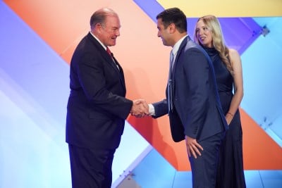 two men shaking hands on stage at richter awards ISM World 2023