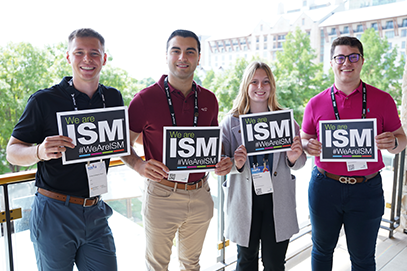 ism conference attendees holding signs