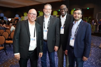 men posing for a picture at ism world 2023 conference
