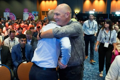 two men hugging at ism world conference