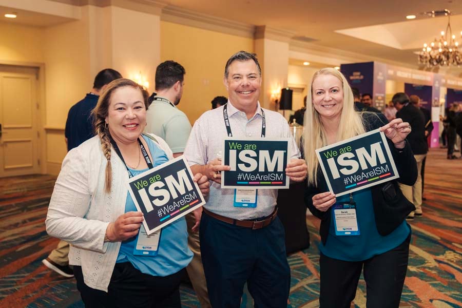 ladies smiling holding ISM sign