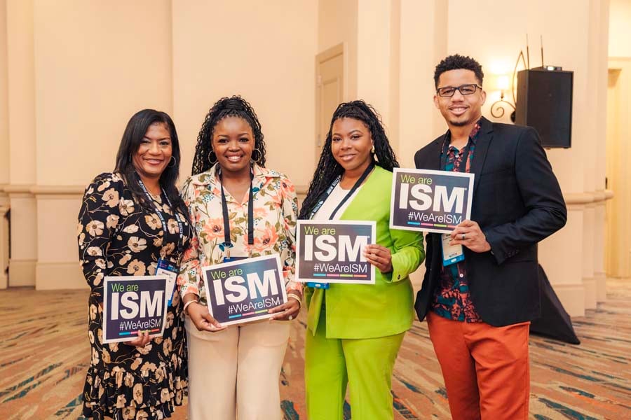 Attendees holding ISM signs