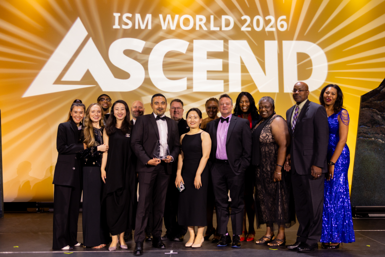 A group of people stand in front of an ISM World 2026 ASCEND