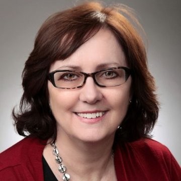 brown hair woman smiling for head shot