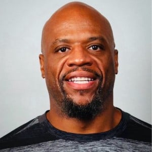 bald man smiling for head shot
