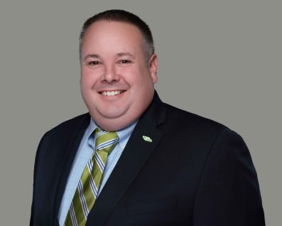 man smiling wearing a suite