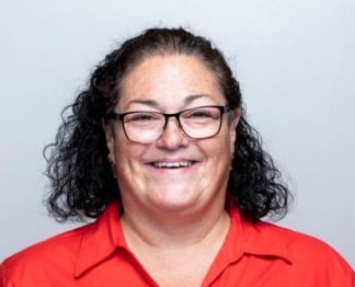 women with glasses smiling red shirt