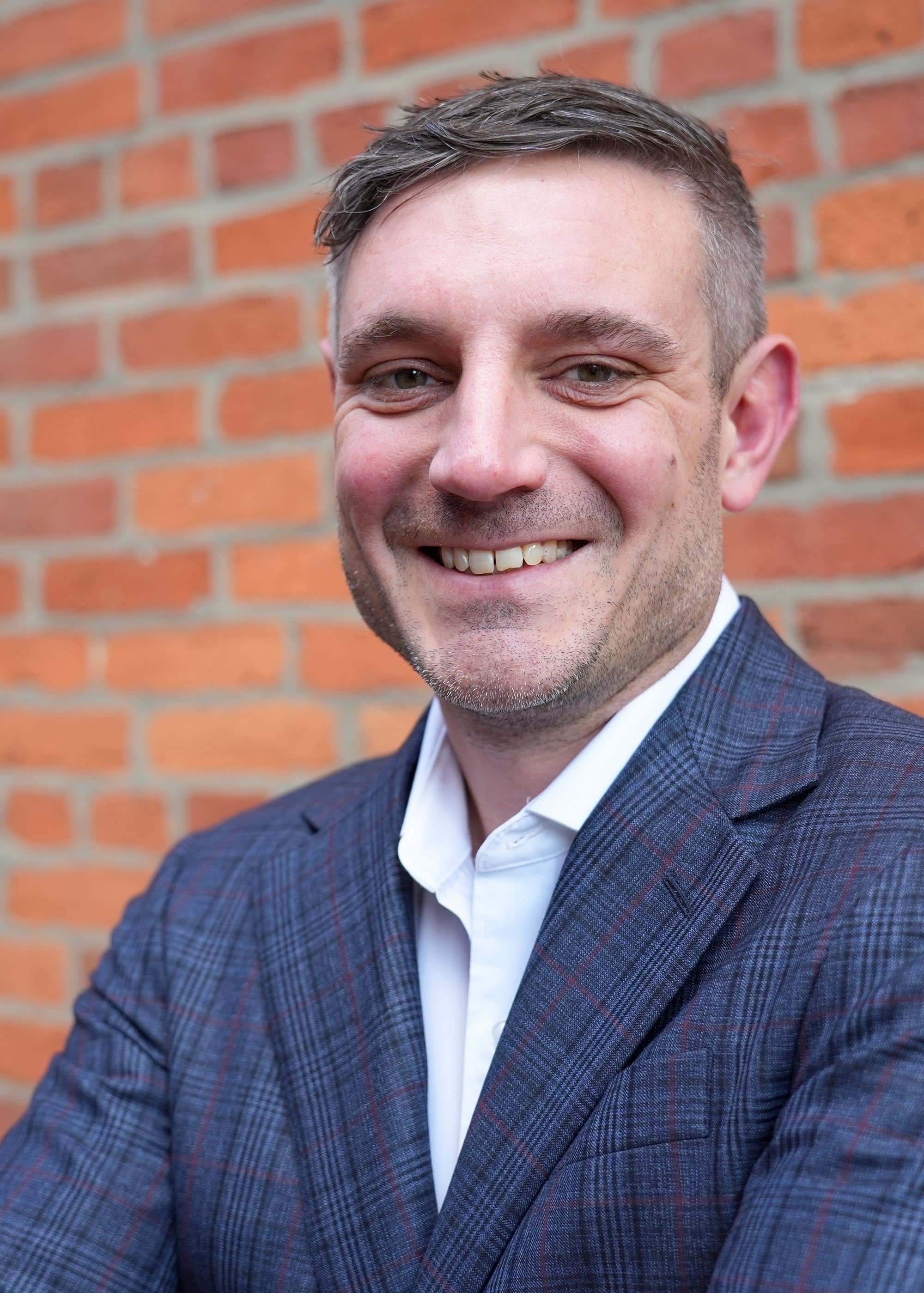 man in blue suite smiling