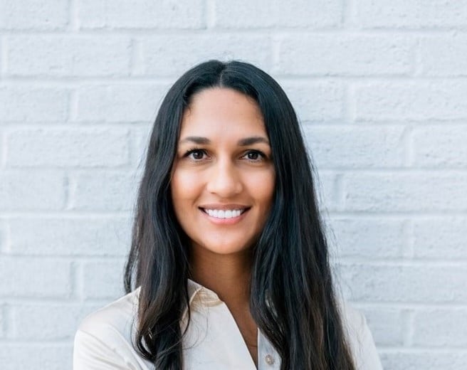 women smiling brown shirt