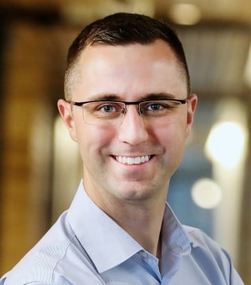 man with glasses smiling